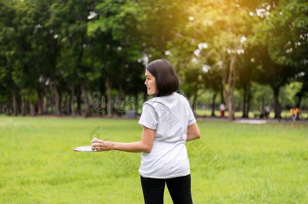 像运动家的亚洲人女人手佃户租种的土地<strong>羽毛球</strong>球拍和<strong>羽毛球</strong>