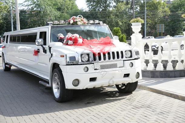 白色的婚礼豪华轿车装饰和红色的带,婚礼戒指