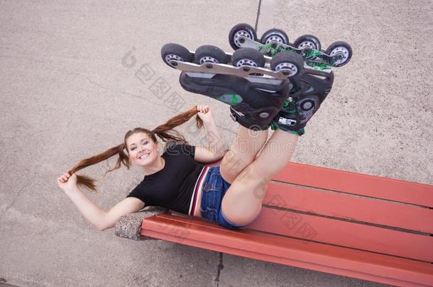 疯狂的女人向长凳使人疲乏的滚筒溜冰鞋