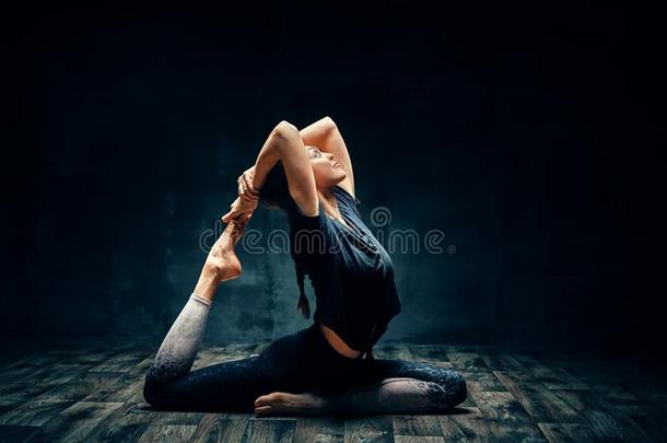 年幼的女人开业的瑜伽做num.一有腿的国王鸽子使摆姿势采用