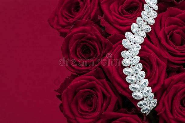 奢侈钻石珠宝手镯和红色的玫瑰花,爱赠品