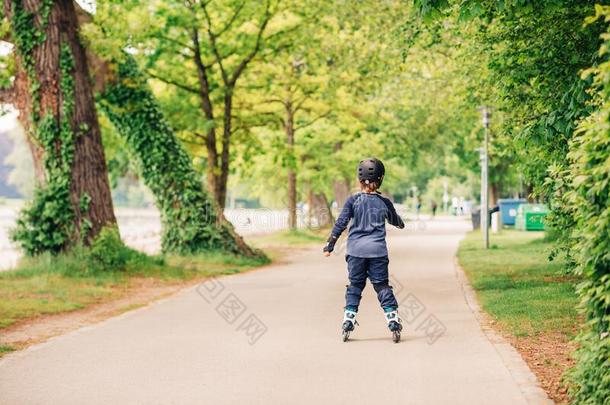 积极的小的男孩溜冰采用夏公园