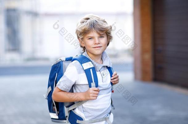 幸福的小的小孩男孩和背包或书包.School小孩向指已提到的人