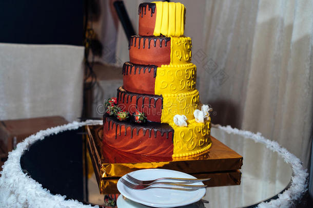 圆形的许多层层排列黄色的和棕色的婚礼蛋糕和稻草人