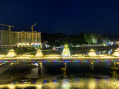 少数民族风雨桥特色建筑夜景灯光航拍摄影图