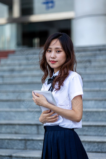 校园里的女大学生学习阅读读书写作业