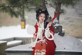 雪天户外身穿中式红色汉服的亚洲少女