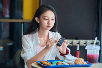 在商场<strong>快餐厅</strong>大吃特吃的中国可爱少女人像