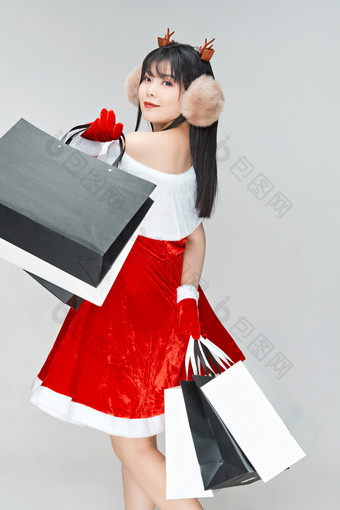 身穿圣诞<strong>服饰</strong>手提购物袋性感可爱的圣诞女郎