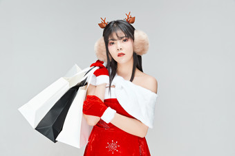 身穿圣诞<strong>服饰</strong>手提购物袋性感可爱的圣诞女郎