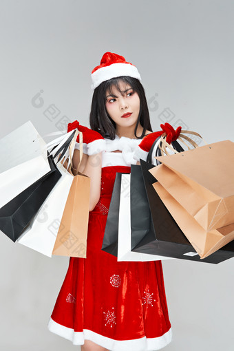 身穿圣诞服饰手提<strong>购物</strong>袋性感可爱的圣诞女郎