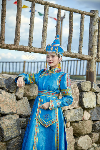 草原上敖包前身穿豪华蒙古族服饰的蒙族少女
