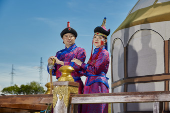 草原上蒙古包前穿蒙古族<strong>传统服饰</strong>的年轻夫妻
