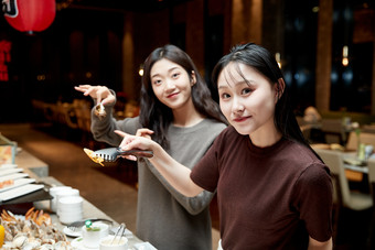 在酒店自助餐厅大吃特吃的亚洲可爱闺蜜少女