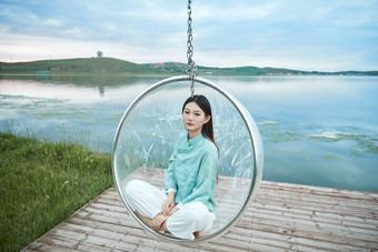 草原湖畔打卡点游玩拍照的亚洲少女
