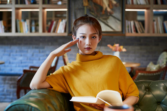 在图书咖啡馆阅读书籍的少女