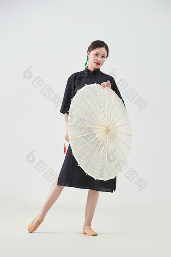 穿中式旗袍手拿油纸伞翩翩舞蹈的亚洲少女舞者