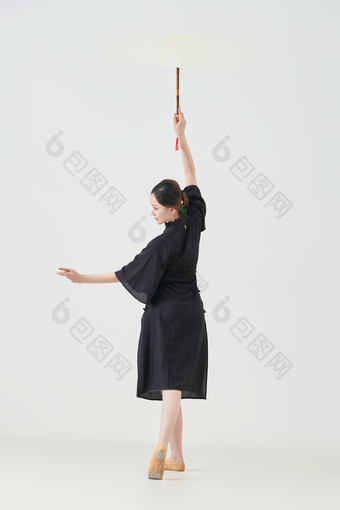 穿中式<strong>旗袍</strong>手拿油纸伞翩翩舞蹈的亚洲少女舞者