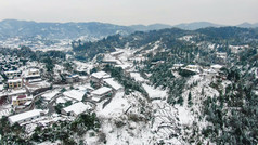 航拍南方丘陵村庄雪景