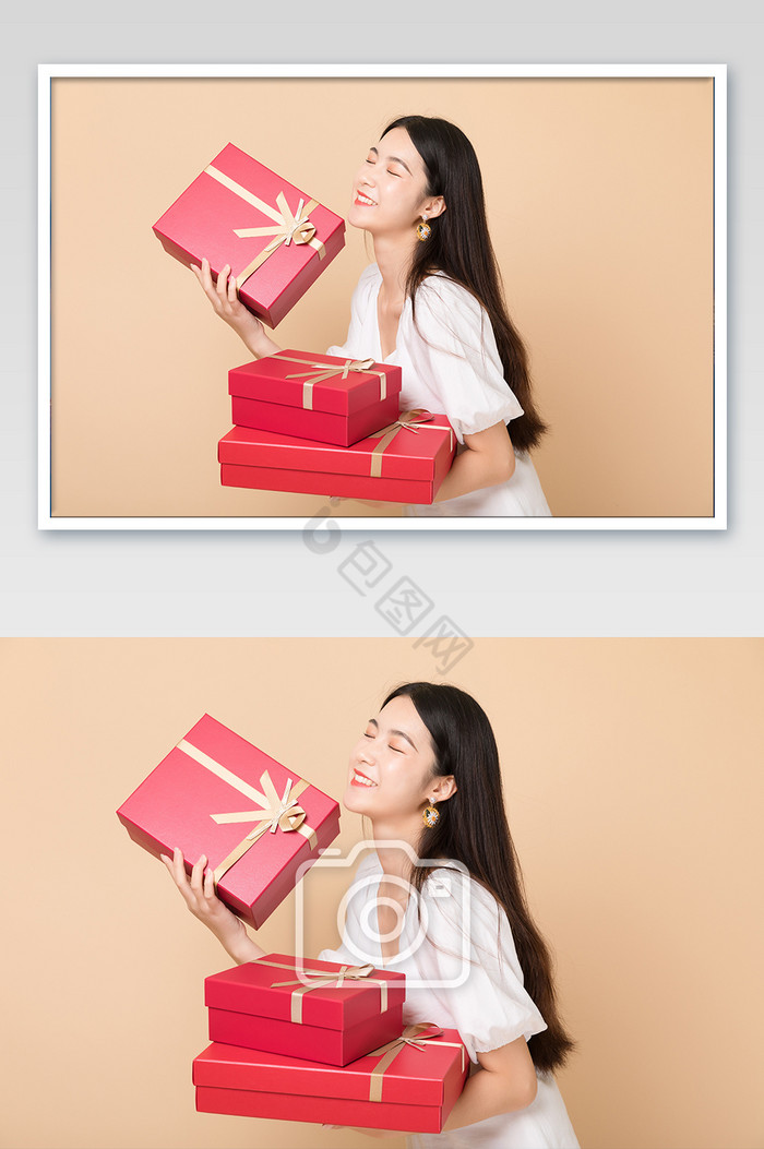 年轻美女开心拿着礼物盒人像图片