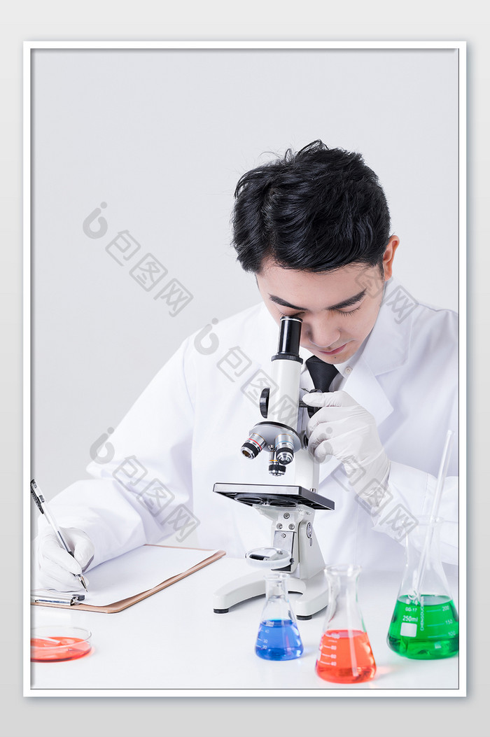 男实验人员进行显微镜观察并记录摄影图片