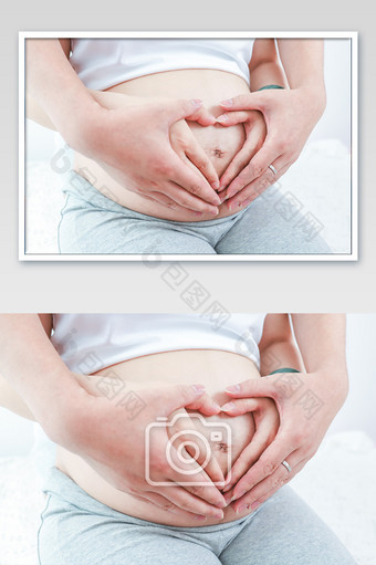 孕妇孕肚父母双手比爱心摄影图图片