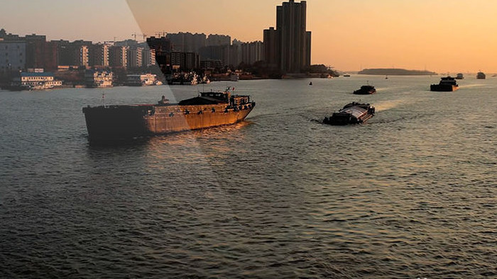 航拍南京长江夕阳下的江面货船来往穿梭