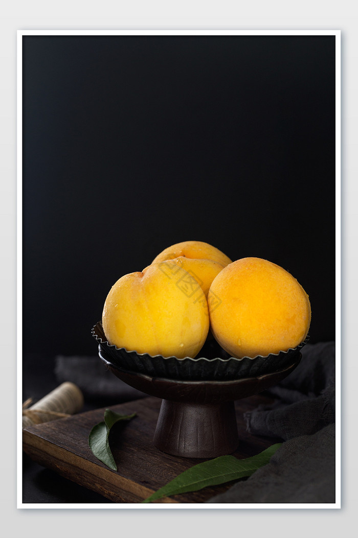 一盘黄桃新鲜果子黑底图片