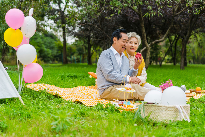 清新老年夫妇野外吃苹果摄影照片图片