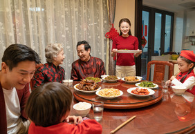 新年全家人团圆饭上菜摄影图片