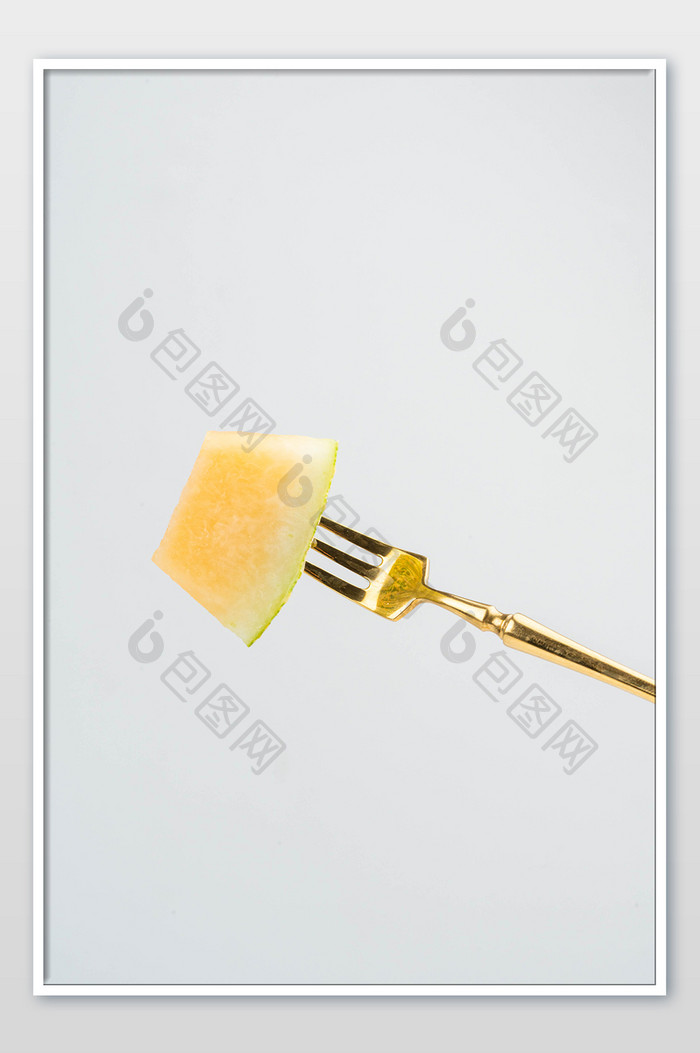 叉子哈密瓜摄影图