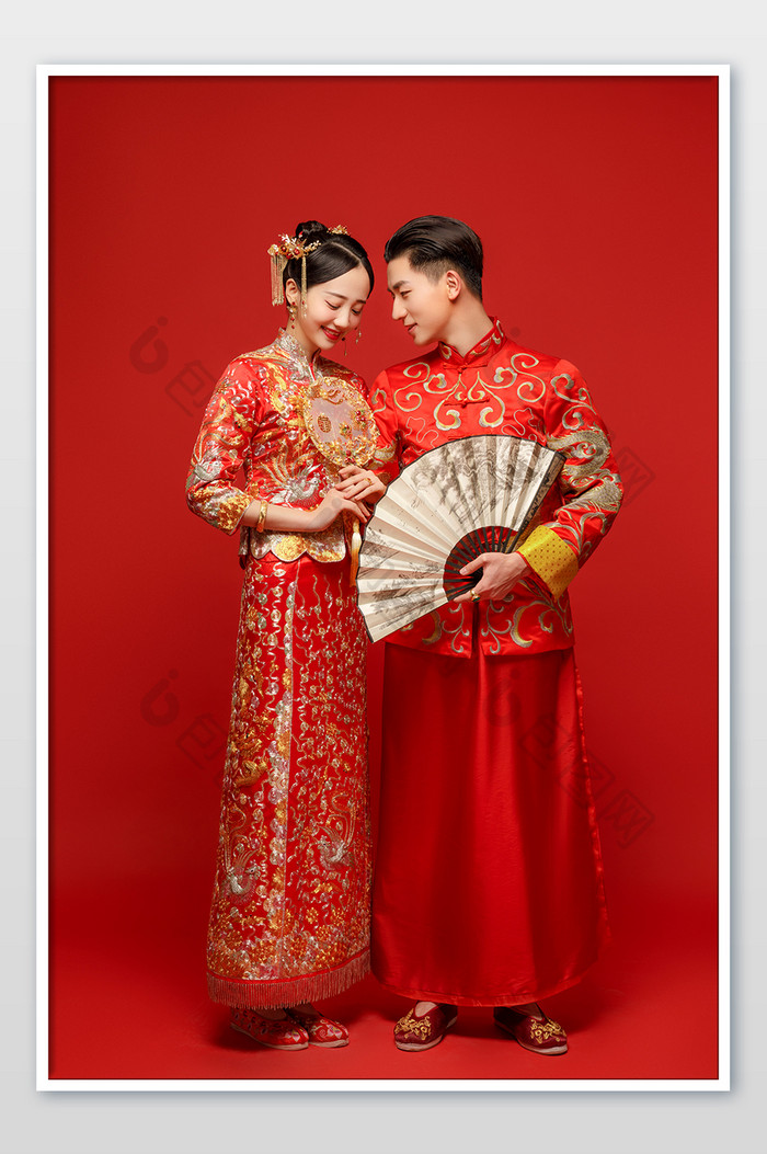 穿着中式传统婚服的新郎新娘对视