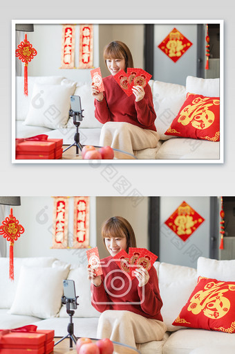 新年春节居家女生对着手机展示红包图片