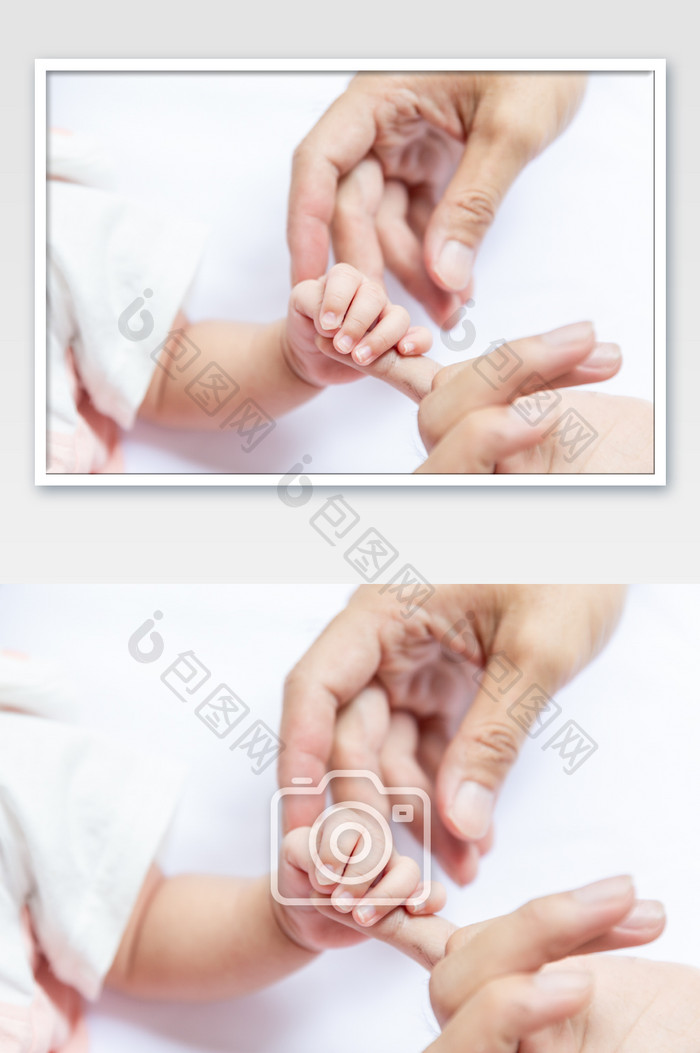 婴儿抓住母亲的手