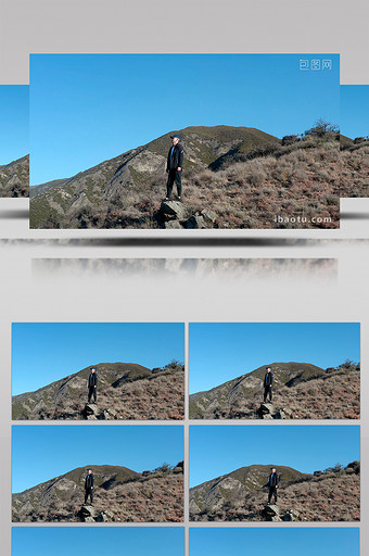 4K实拍小伙子站在山上仰望蓝天视频素材图片