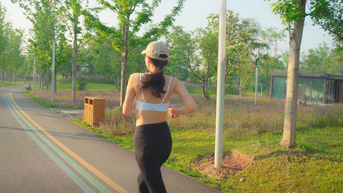 4K实拍阳光下女子在马路上跑步视频素材