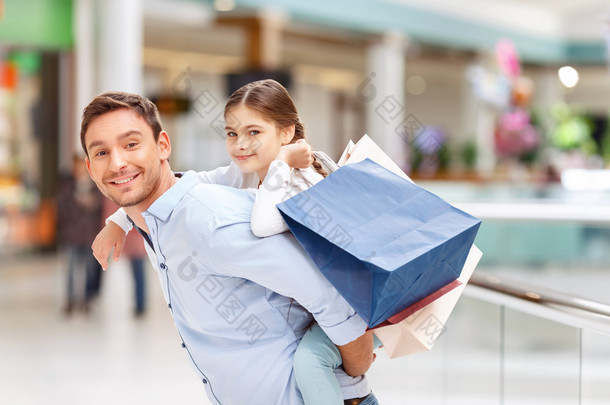 Father and daughter having fun in <strong>shopping</strong> mall