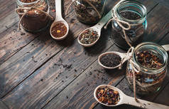 不同种类的茶罐和木制的勺子在木桌上