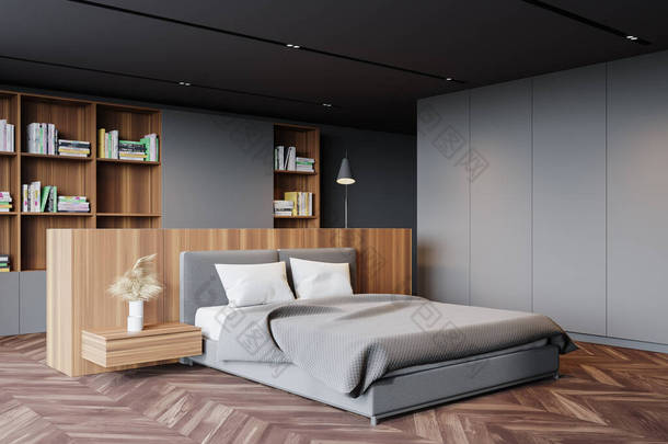 现代主卧室的内部有灰色的<strong>墙</strong>壁，深色的木制地板，舒适的国王尺寸的床和<strong>书柜</strong>。3d渲染