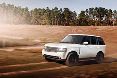 Car drive speed fast on the dirty off-road range rover