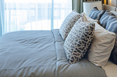 pillows on blue sofa with lamp