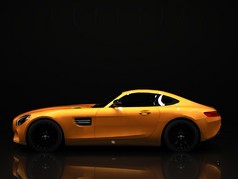 Sports car left view. The image of a sports gold car on a black background.