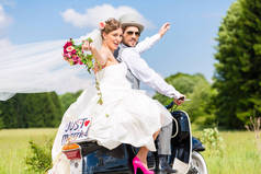 在摩托车上的新婚夫妇刚结婚