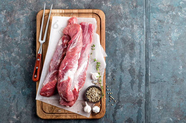 新鲜的生猪肉里脊木菜板上深色背景上