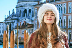 对路堤在威尼斯，意大利冬季轻松的旅游女人