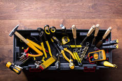 在木桌上设置的许多黄色修理工具的顶上的看法