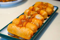 A plate of traditional Sichuan snacks, cakes with sugar and oil