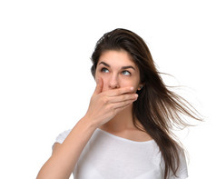 beautiful young woman covering her mouth with hand