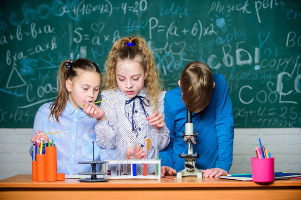 太不可思议了实验室里的小孩在学校实验室学习化学的小孩。学生们用显微镜做生物实验。化学显微镜。实验室显微镜。儿童节