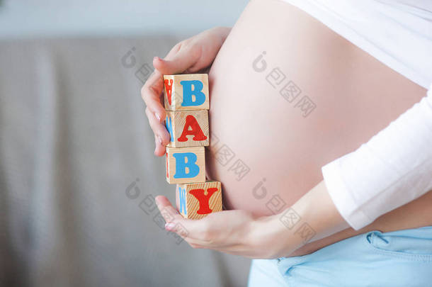 年轻的孕妇在室内。 女人期待的特写。 漂亮的女性在等着她的小<strong>宝宝出生</strong>.